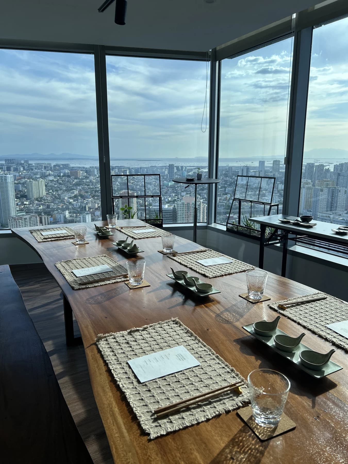 Private Japanese Wagyu tasting table set beside a daytime Makati skyline view